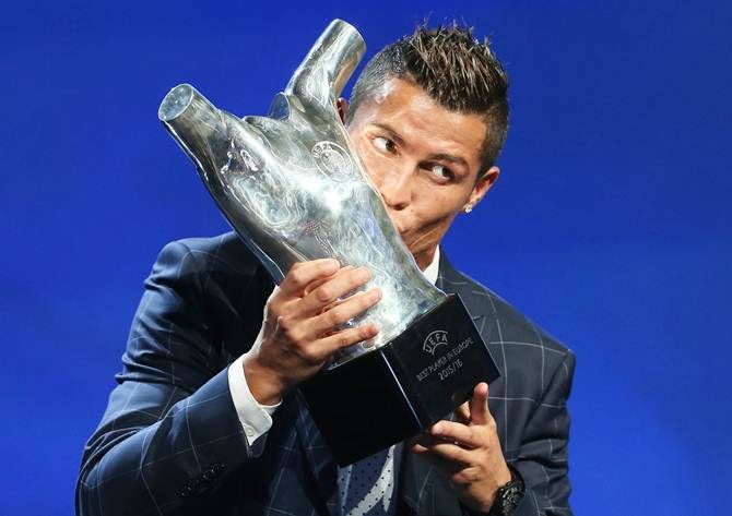 Real Madrid's Cristiano Ronaldo of Portugal kisses the 'Best Player UEFA 2015/16' trophy during the draw ceremony for the 2016-17 Champions League at Monaco's Grimaldi in Monaco, on Thursday, August 25