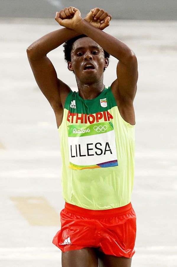 Feyisa Lilesa of Ethiopia celebrates as he crosses the line to win silver at the Rio Olympics