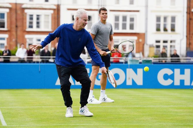 US tennis great John McEnroe and Canada's Milos Raonic during a practice session