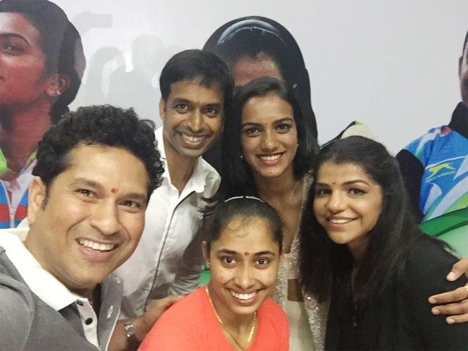 India's cricketing legend Sachin Tendulkar takes a selfie with India's badminton coach Pullela Gopichand and Rio Olympians PV Sindhu, Sakshi Malik and Dipa Karmakar after gifting them BM cars on Sunday