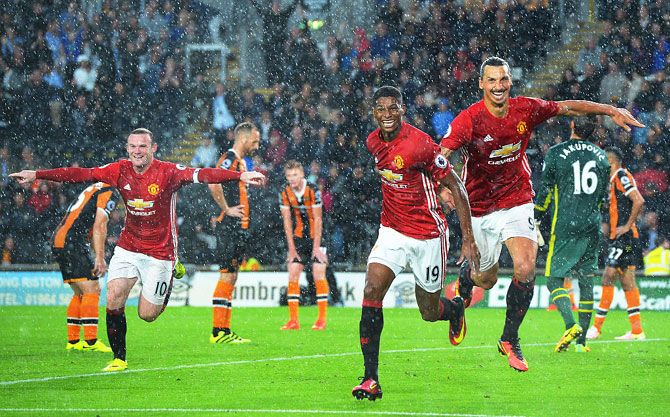 Manchester United's Marcus Rashford (centre) celebrates scoring the first goal with teammates Wayne Rooney (left) and Zlatan Ibrahimovic during the English Premier League match against Hull City at KCOM Stadium in Hull on Saturday