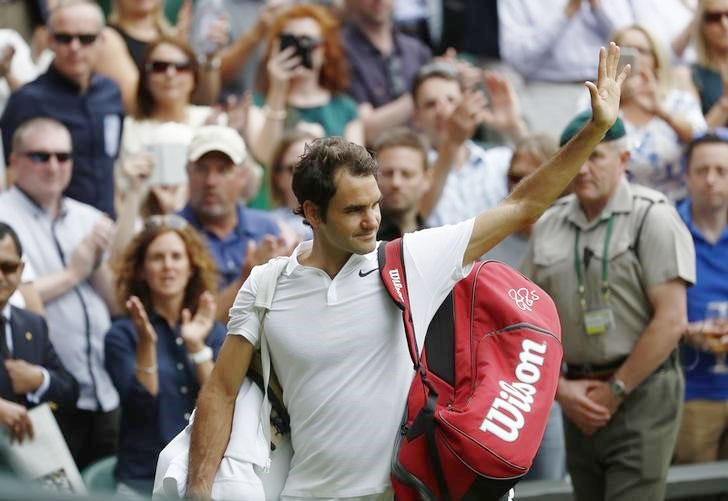 Switzerland's Roger Federer waves to the crowd as he walks off court