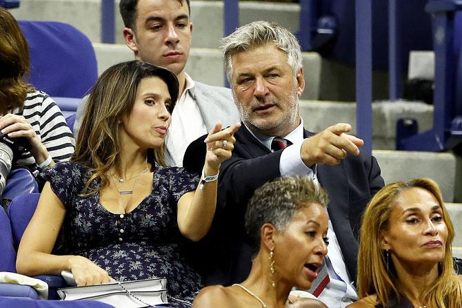 Hilaria Thomas and Alec Baldwin watch the first round match between Novak Djokovic and Jerzy Janowicz