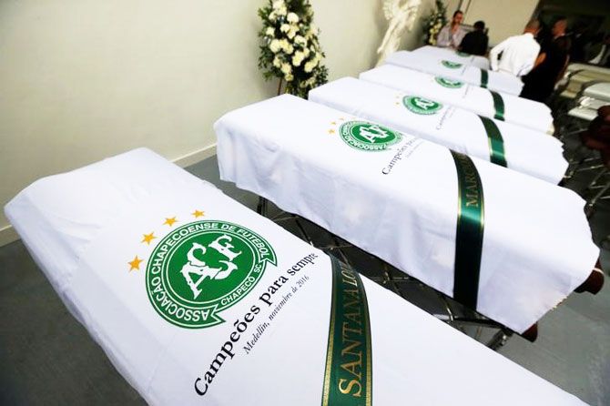 Blankets bearing the crest of Brazilian soccer team Chapecoense are placed on coffins holding the remains of the victims on December 1
