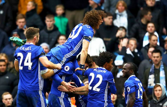 Chelsea players including David Luiz (top) celebrate their team's third goal during their Premier League match against Manchester City 