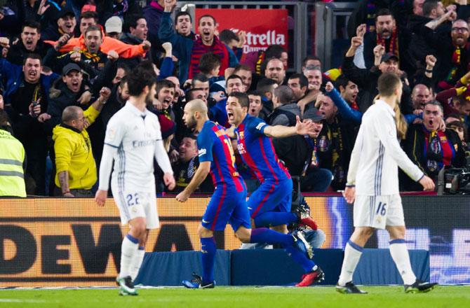 Luis Suarez (2nd from right) celebrates with teammate Javier Mascherano after scoring the opening goal