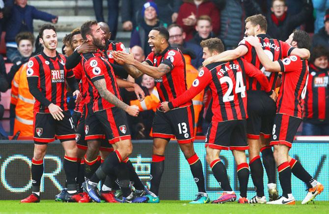 AFC Bournemouth's Steve Cook (3rd from left) celebrates with teammates as he scores their third goal against Liverpool during their English Premier League match at Vitality Stadium in Bournemouth on Sunday