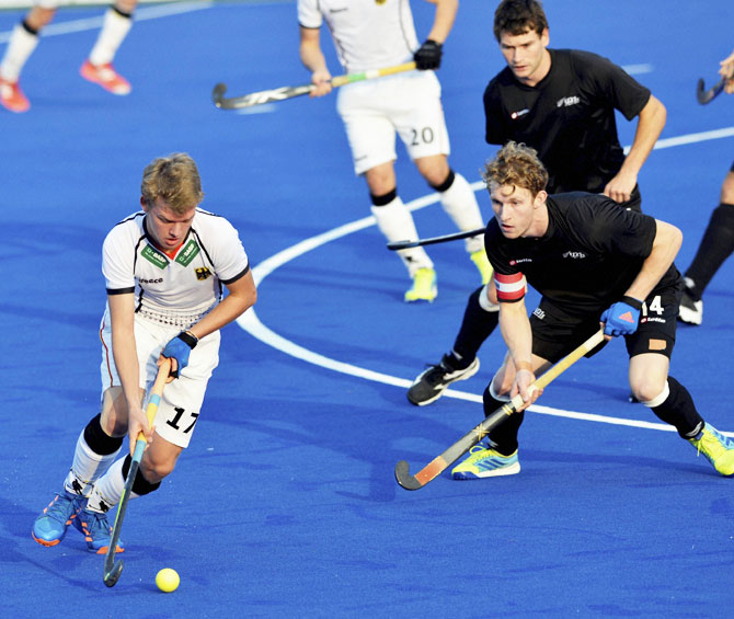 Germany's Ole Thies Prinz is prevented by New Zealand players during their match at Jr. World Cup Hockey Tournament at Major Dhyanchand Stadium in Lucknow on Friday