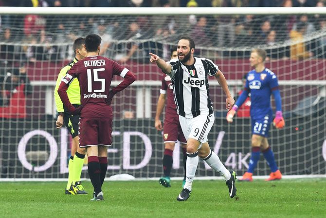 Juventus FC's Gonzalo Higuain (right) celebrates a goal during the Serie A match against FC Torino at Stadio Olimpico di Torino in Turin on Sunday