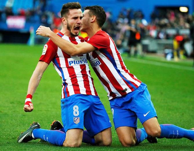 Atletico Madrid's Saul Niguez (left) celebrates with teammate Lucas Hernandez after scoring against Las Palmas at the Vincente Calderon Stadium in Madrid on Saturday