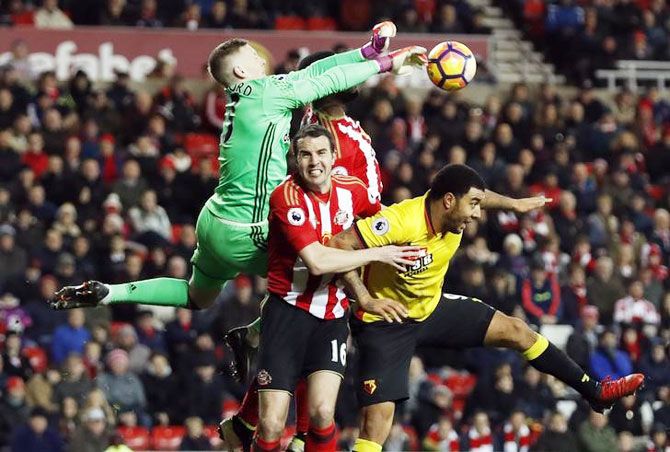 Sunderland's Jordan Pickford and John O'Shea vie with Watford's Troy Deeney during their match at the Stadium of Light