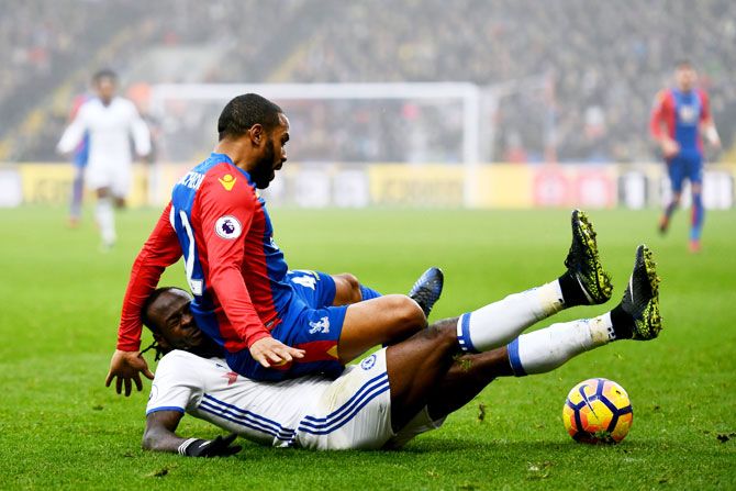 Chelsea's Victor Moses (left) fouls Crystal Palace's Jason Puncheon (right)