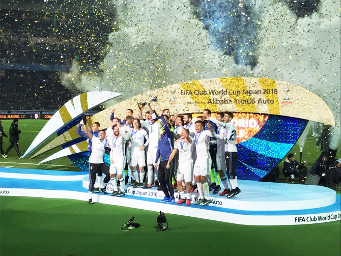 Real Madrid players celebrate with the Club World Cup trophy on Sunday