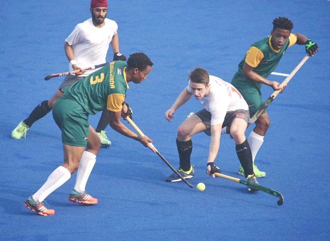 Players battle for the puck during the South Africa vs Canada Jr. World Cup Hockey match in Lucknow on Saturday