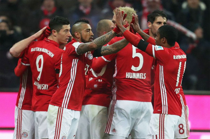 Bayern Munich players celebrate a goal during their Bundesliga match against RB Leipzig at Allianz-Arena in Munich on Wednesday