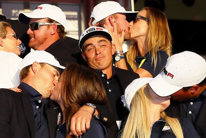 Rickie Fowler of the United States wears a funny look as J.B. Holmes, Erica Holmes, Jimmy Walker, Erin Walker, Jordan Spieth, Annie Verret, Justine Reed and Patrick Reed celebrate during singles matches of the 2016 Ryder Cup at Hazeltine National Golf Club in Chaska, Minnesota, on October 2