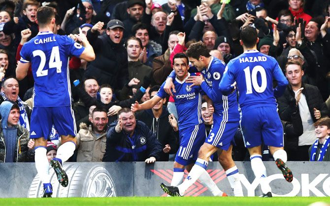 Chelsea's Pedro celebrates with teammates after scoring the first goal against AFC Bournemouth during their English Premier League match at Stamford Bridge in London on Monday