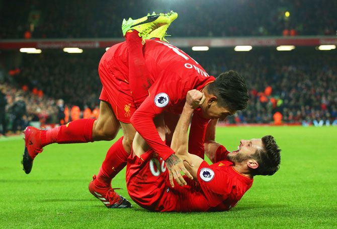 Liverpool's Roberto Firmino (left) celebrates with Adam Lallana as he scores their second goal during their English Premier League match against Stoke City at Anfield in Liverpool on Tuesday