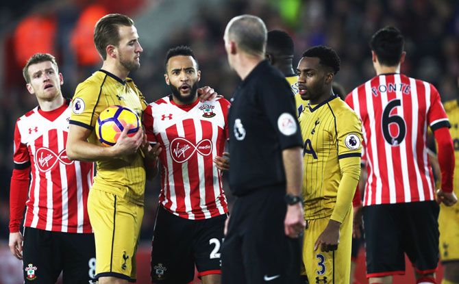 Southampton's Nathan Redmond is restrained by Tottenham Hotspur's Harry Kane as he is sent off by referee Mike Dean