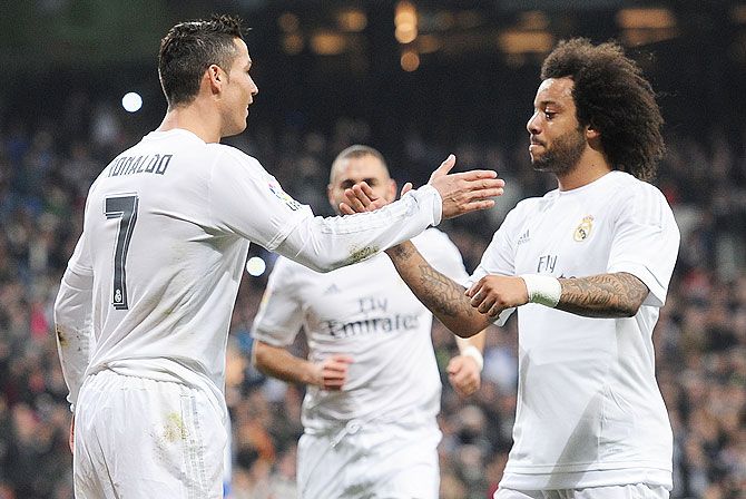 Real Madrid's Cristiano Ronaldo celebrates with teammate Marcelo after scoring during the La Liga match against Espanyol at Estadio Santiago Bernabeu on Sunday