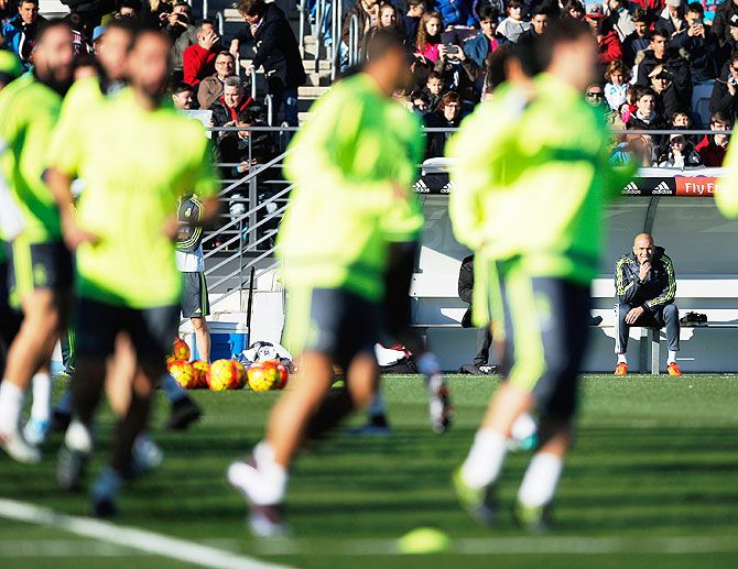 Real Madrid's manager Zinedine Zidane watches his players during a team training session at Valdebebas training ground in Madrid