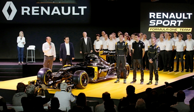 Renault Chief Executive Carlos Ghosn (second left), Formula One racing driver Kevin Magnussen of Denmark (right)  