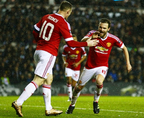 Juan Mata of Manchester United (8) celebrates with Wayne Rooney as he scores their third goal during an FA Cup fourth round match against Derby County