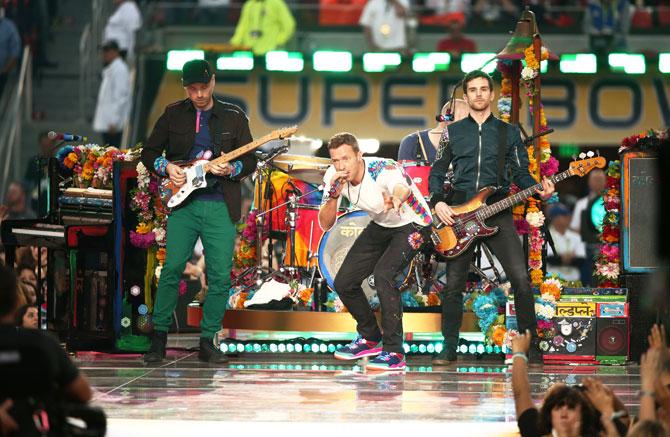 Jonny Buckland, Chris Martin, Guy Berryman and Will Champion of Coldplay perform onstage during the Pepsi Super Bowl 50 Halftime Show at Levi's Stadium in Santa Clara, California, on Sunday