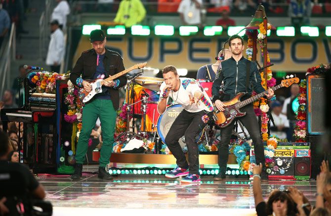 Jonny Buckland, Chris Martin, Guy Berryman and Will Champion of Coldplay perform onstage during the Pepsi Super Bowl 50 Halftime Show at Levi's Stadium in Santa Clara, California, on Sunday