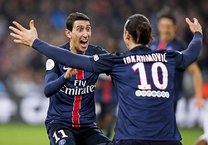 Paris St Germain's Angel Di Maria (left) celebrates with teammate Zlatan Ibrahimovic after scoring against Olympique Marseille during their French Ligue 1 match at Velodrome stadium in Marseille on Sunday