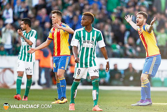 Valencia's players show their frustration over a decision during their match against Real Betis on Sunday