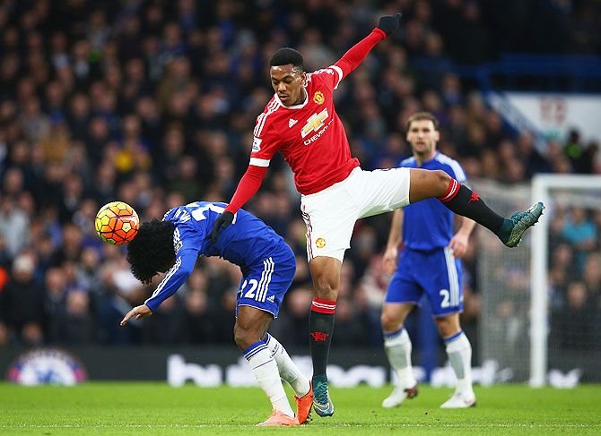 Manchester United's Anthony Martial tackles Chelsea's Willian during their EPL match on Sunday