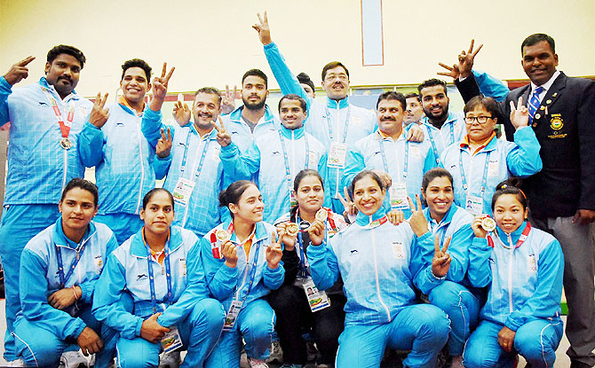 The Indian contingent poses for a group photograph after the end of Weightlifting events at the 12th South Asian Games in Guwahati on Tuesday
