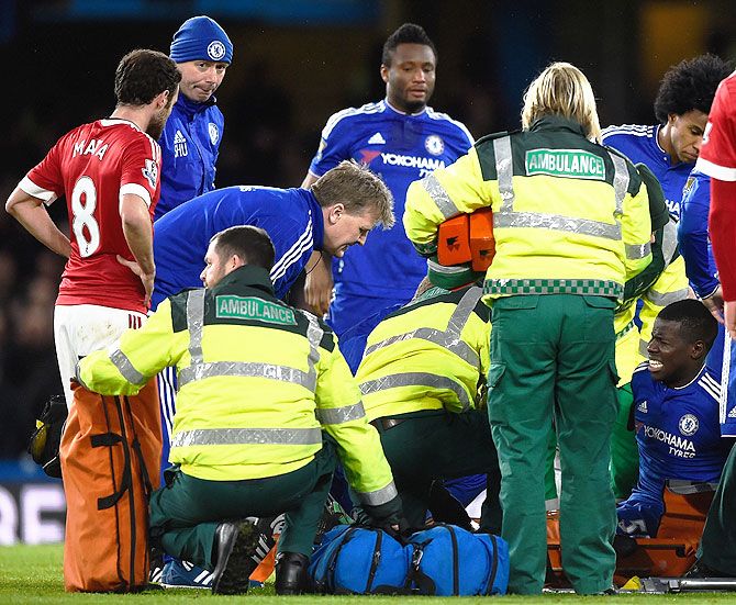 Chelsea's Kurt Zouma (right) winces in pain as he is checked on by paramedics after picking up an injury during the Barclays English Premier League match against Manchester United at Stamford Bridge on Sunday