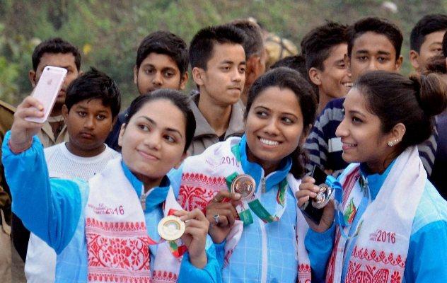 India's Apurvi Chandela, Pooja Ghatkar, Elizabeth Susan taking selfie during the presentation ceremony for the 10m Air Rifle event 