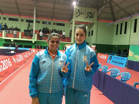 Pooja Sahasrabudhe and Manika Batra showing victory sign after winning gold medal in the women's doubles table tennis event 