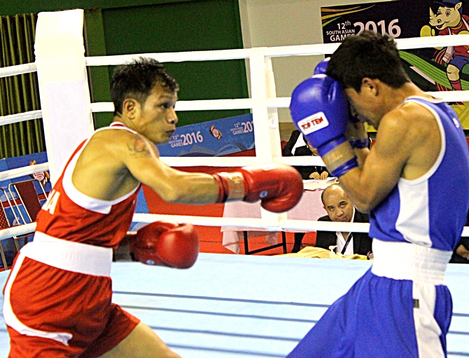 India’s Devendro Singh, left, throws a jab at his opponent during the South Asian Games in Shillong