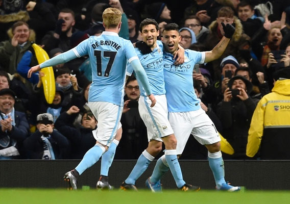 Manchester City's Sergio Aguero is congratulated by teammates David Silva and Kevin De Bruyne after scoring