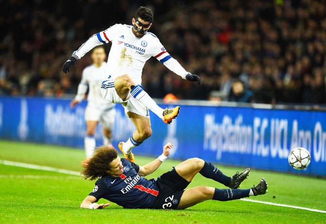 Paris Saint-Germain's David Luiz slides to tackle Chelsea's Diego Costa
