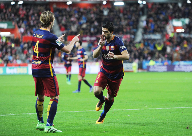 FC Barcelona's Luis Suarez celebrates with teammate Ivan Rakitic after scoring his team's 3rd goal
