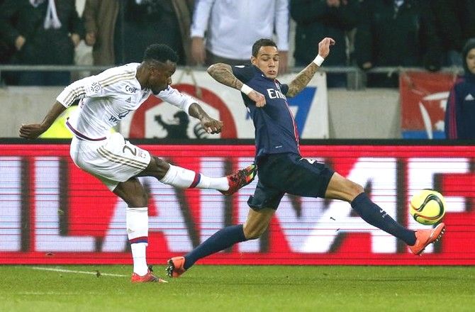 Olympique Lyon's Maxwel Cornet (left) shoots to score past Paris St-Germain's Gregory Van Der Wiel during their Ligue 1 match at the Grand Stade stadium, in Decines, France on Sunday