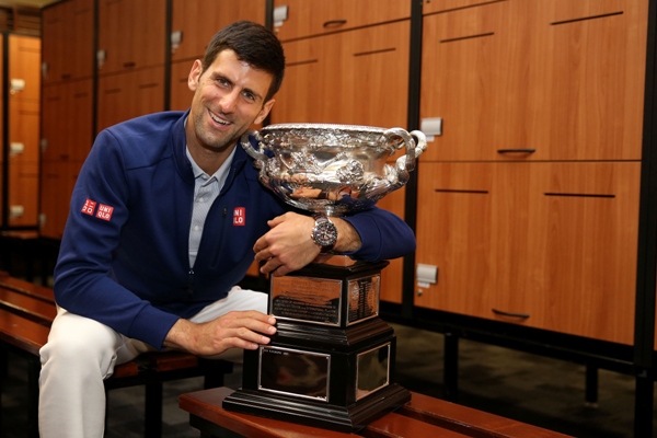 Novak Djokovic of Serbia poses with the Norman Brookes Challenge Cup in the players change rooms 