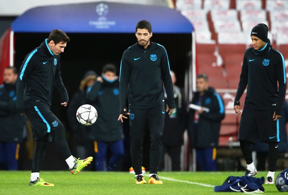 Lionel Messi (left) is watched by team mates Luis Suarez (centre) and Neymar during a FC Barcelona training session