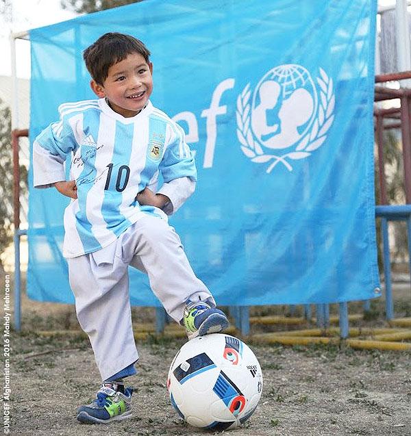 Five-year-old Afghan boy Murtaza Ahmadi shows off the gifts he received from Lionel Messi