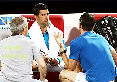 Serbia's Novak Djokovic receives medical attention on court during his Dubai Open quarter-final against Spain's Feliciano Lopez at the Dubai Duty Free Stadium in Dubai, United Arab Emirates, on Thursday