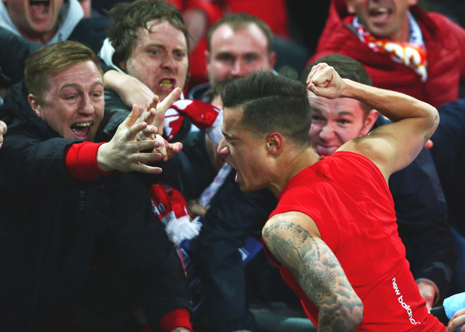 Fans celebrate with Liverpool's Philippe Coutinho as he scores their first and equalising goal against Manchester City