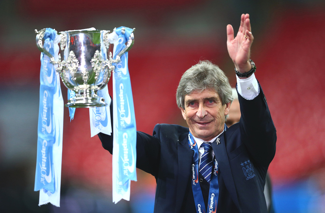 Manchester City manager Manuel Pellegrini celebrates with the League Cup trophy