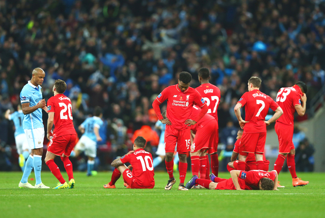 Liverpool's Daniel Sturridge (15) and teammates wear a dejected look after defeat