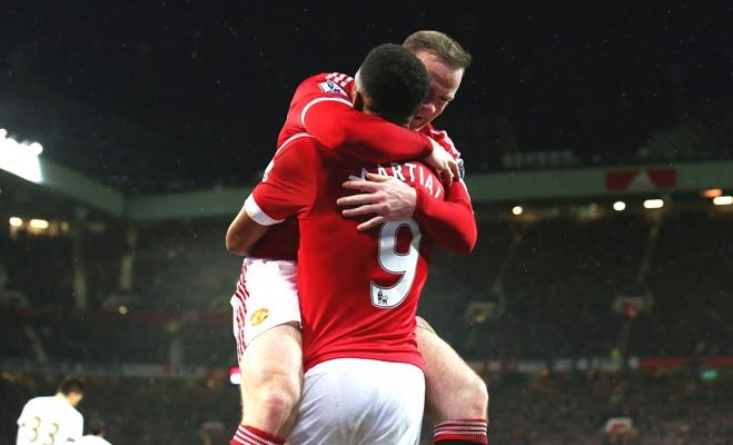 Wayne Rooney of Manchester United celebrates scoring his team's second goal during their Premier League match against Swansea City at Old Trafford