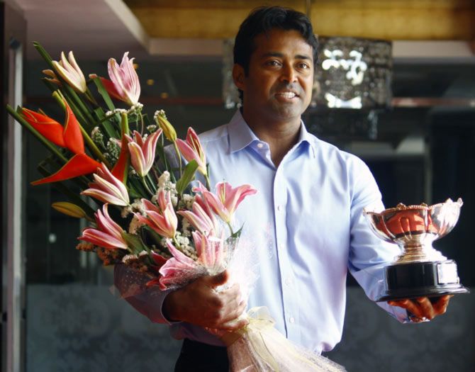 Leander Paes poses with the 2015 Australian Open mixed doubles trophy in Mumbai